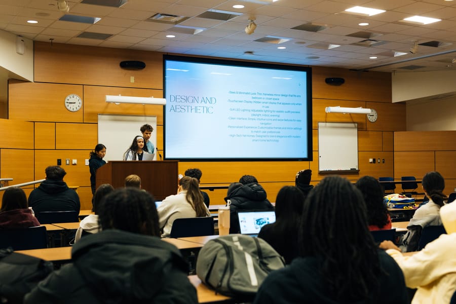 SparkLab teams presenting in a Michigan high school lecture hall